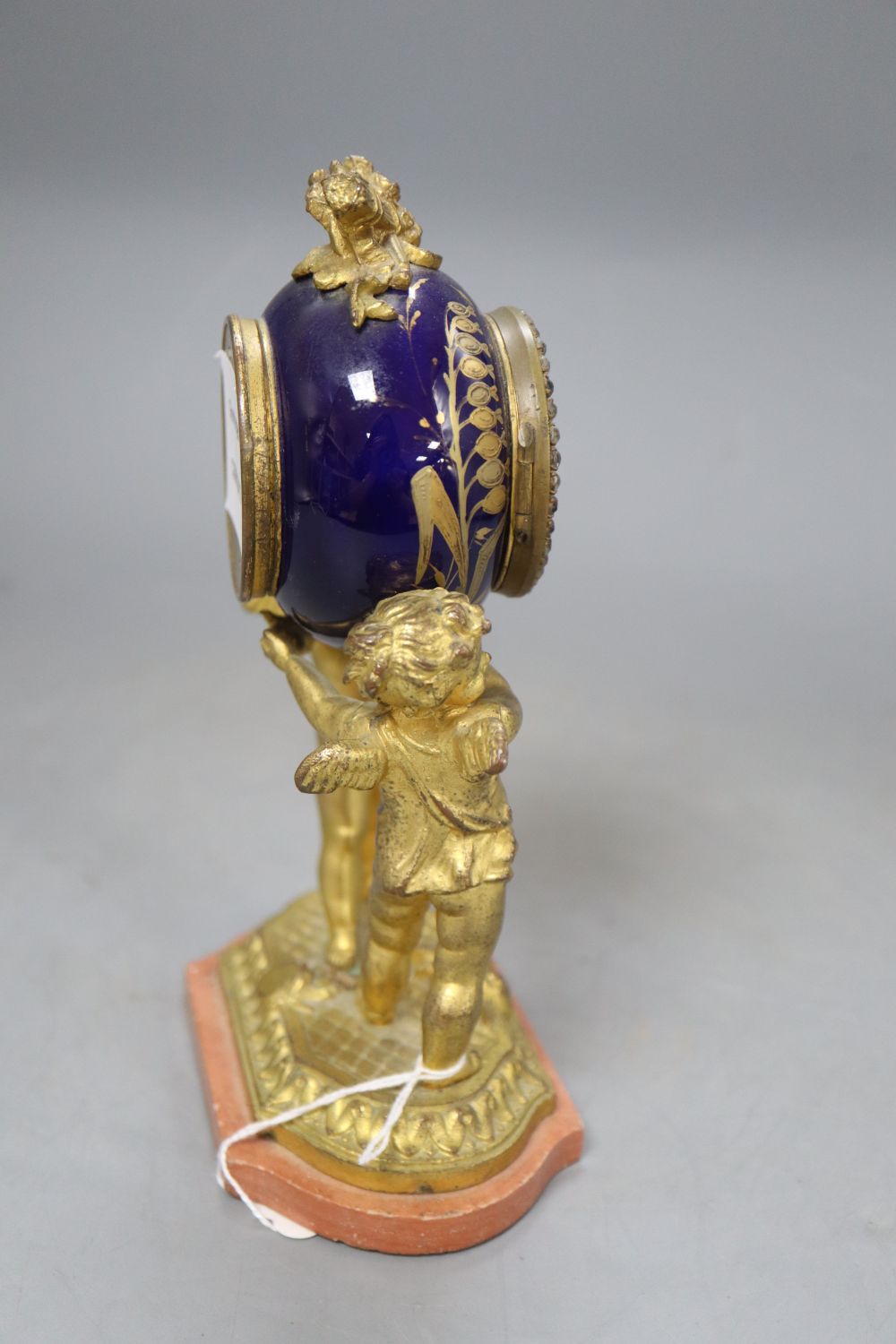 A French gilt metal and enamel cherub timepiece, height 18.5cm